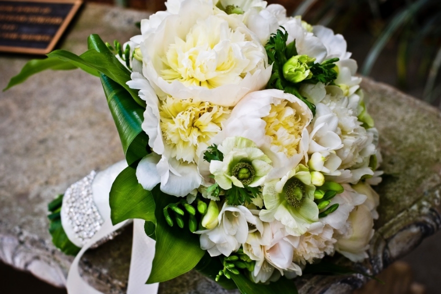 Beautiful bouquet made of white and green flowers with lush peonies
