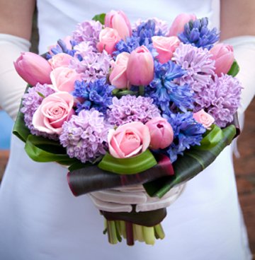 Pink tulips pink roses and hyacinths make up this lovely bridal bouquet
