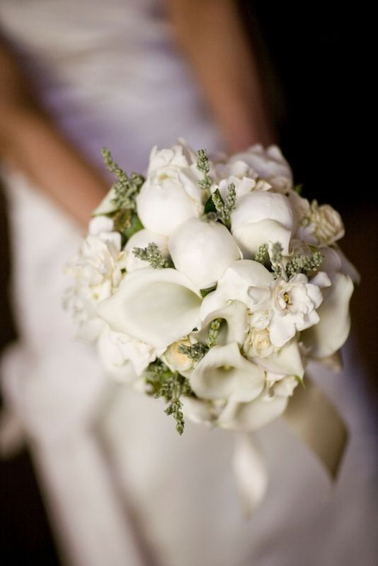 An amazing white bridal bouquet made up of white peonies gardenias and