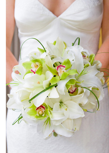 Amazing bridal bouquet made of white lilies green orchids and bear grass