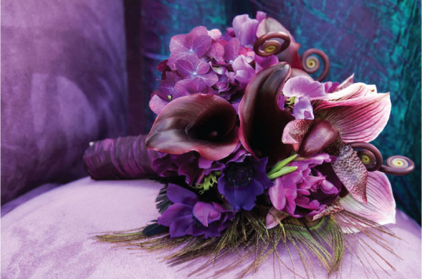 Lush and stunning purple bouquet with peacock feathers