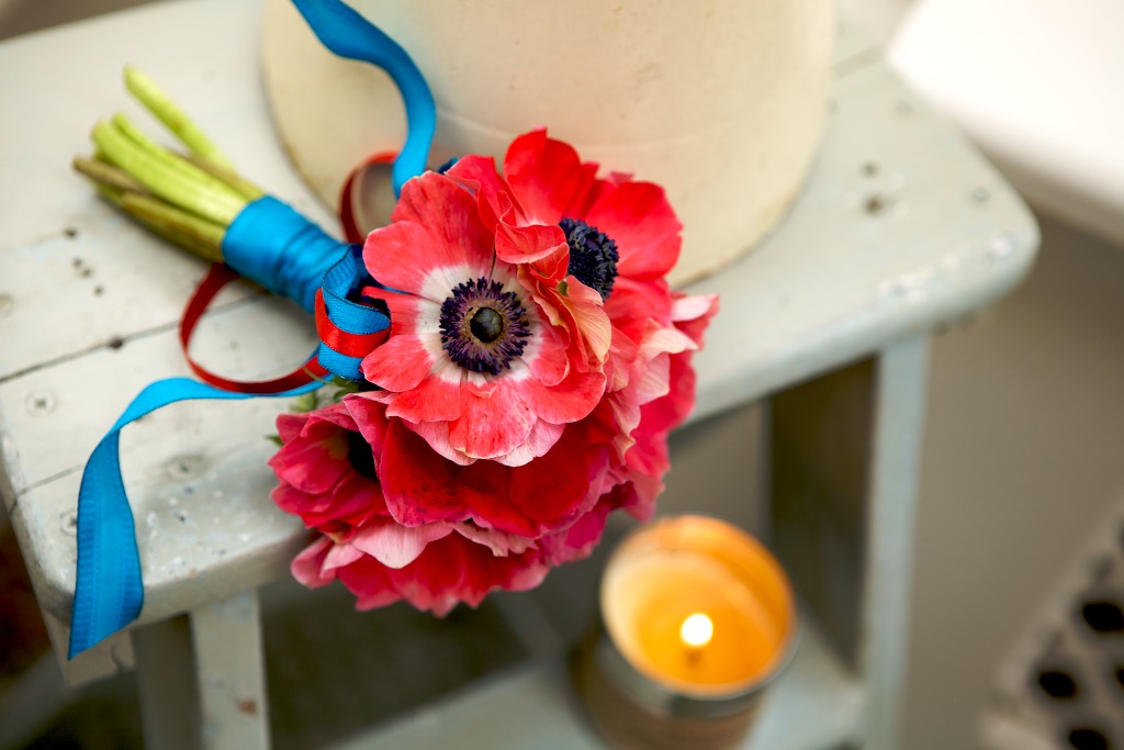 Beautiful big red anemone bouquets hand tied with bright blue ribbon