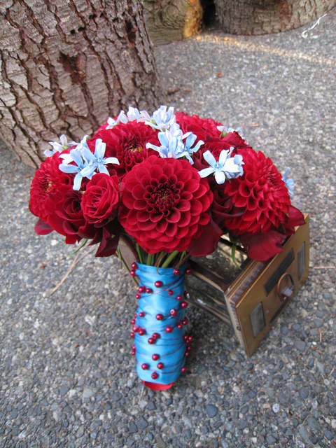 Amazingly beautiful bright red with light blue wedding bouquet made up of 