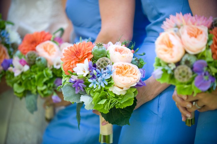 The bridesmaids’ bouquets of green hydrangea, Juliet roses, dahlias, tweedia, freesia, sweetpeas, scabiosa and poppy pods with dusty miller.