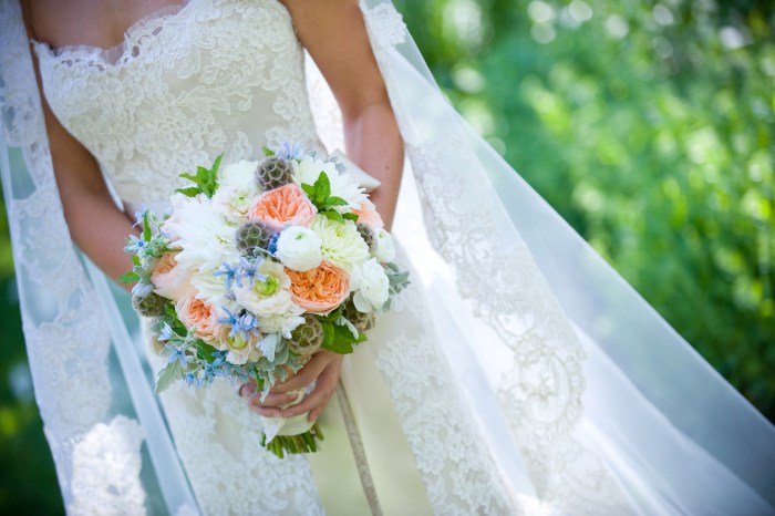 Maggie holding her bridal bouquet of dahlias Juliet garden roses blue 
