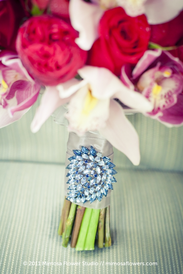 Absolutely amazing bridal bouquet in red purples and pinks created by 