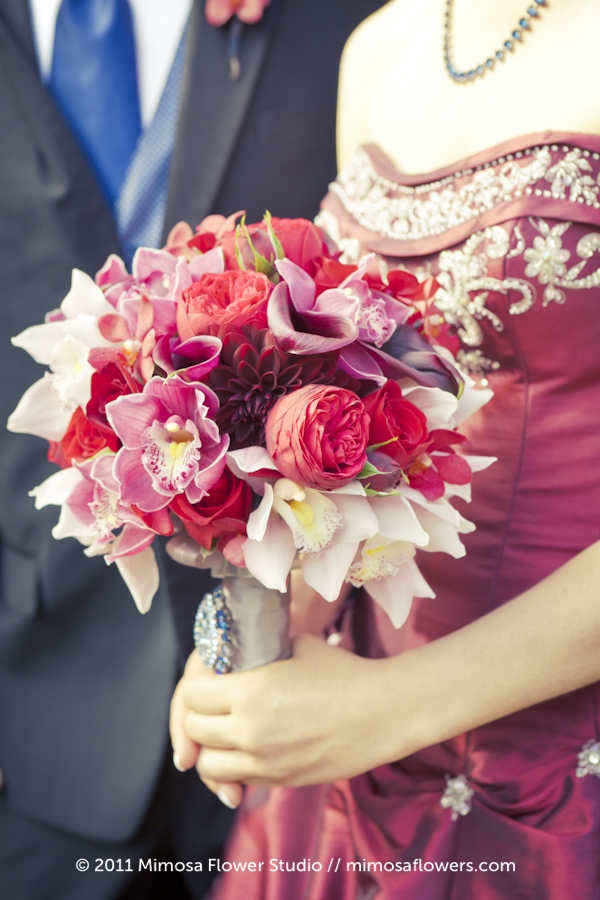 Absolutely amazing bridal bouquet in red purples and pinks created by