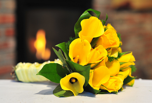 Beautiful yellow bouquet featuring callas and roses stems wrapped with pale 