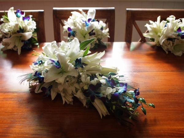 Beautiful bridal bouquet made of white lilies and blue orchids with gorgeous