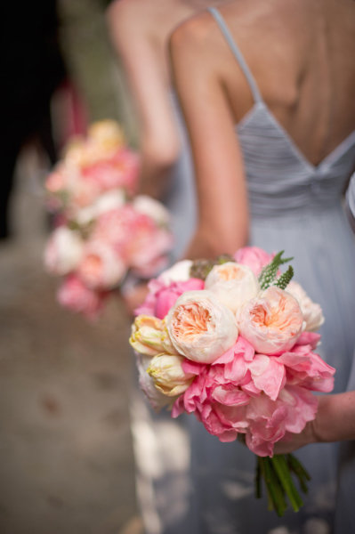 Stunning bride and bridesmaids bouquets featuring peach pink and white