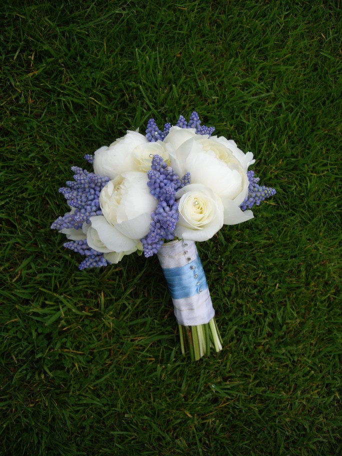 Beautiful unique blue and white bridal bouquet made up of white peonies and