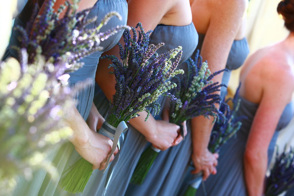 Unique purple and white wedding bouquet for the bridesmaids featured in a