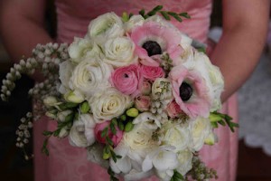 Bridesmaid’s bouquet of roses, ranunculus, anemones, freesias and pierus