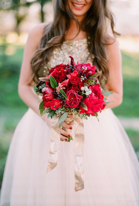 Red bouquet of peonies, garden roses, Annabelle roses, silver brunia berries, and greener