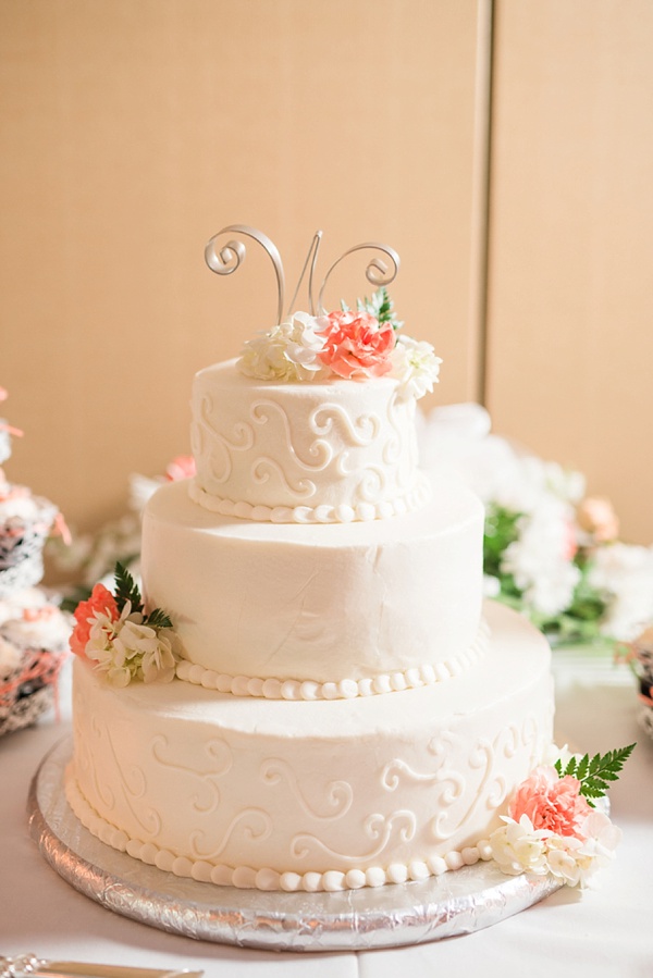 Circular three tier wedding cake in white with white frosted swirls